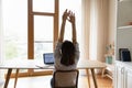 Woman accomplish work lean on chair with raised arms