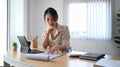 Woman accountant analizing business data and working with computer tablet at office desk.