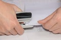 Woman accountant using stapler with documents on table, close-up Royalty Free Stock Photo