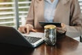 Woman accountant working on desk using mobile phone and calculator concept finance and accounting Royalty Free Stock Photo