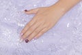 Woman acrylic fingernail painting beautiful white color gel nail art decorated with cute 3D rose flower sparkling rhinestone sweet