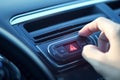 Woman activates car emergency light, man presses red triangle button Royalty Free Stock Photo