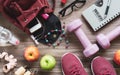 Woman active healthy lifestyle concept. Creative flat lay of sport and fitness equipments with woman accessories, apples, bottle