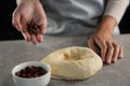 Woman adding chocolate chips into the dough