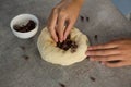 Woman adding chocolate chips into the dough