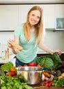 Woman adding spices or salt to the pot Royalty Free Stock Photo