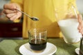 Woman adding sugar in her espresso Royalty Free Stock Photo