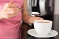 Woman adding sugar to the coffee Royalty Free Stock Photo