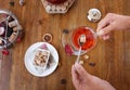 Woman adding sugar to a red berry tea. Top view of buttered cookies and tea kettle. Sweet breakfast. Cosiness concept. Royalty Free Stock Photo