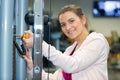 Woman adding weights on gym machine