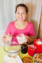 Woman adds sugar into dish