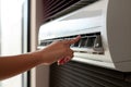 Woman adjusting air conditioner at home, closeup of her hand, Close-up of a man\'s hand using a remote control to mana