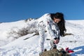 Woman Adjusting her Ski Gear at the Snow