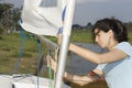 Woman Adjusting Sail Rigging - Horizontal Royalty Free Stock Photo