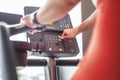 Woman adjusting stepmill in gym closeup