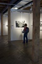 Woman Admires Art at Gallery Event