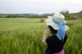 Woman admires green wheat field
