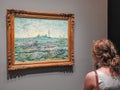 A woman admires a painting by Van Gogh Royalty Free Stock Photo