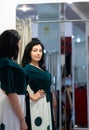 Woman admiring herself in a mirror in a store Royalty Free Stock Photo