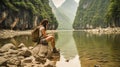 Woman admiring nature by a river in a serene fluvial landscape.