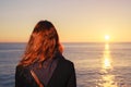 Woman admiring the sea at sunset