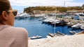 Woman admiring seascape with yachts, seagulls flying close, pleasant rest