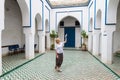 Woman admiring traditional moroccan architecture in one of the palaces in medina of Marrakesh, Morocco. Royalty Free Stock Photo