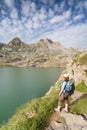 Woman admiring the views of Estanes lake during sunrise