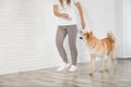 Woman with adorable Akita Inu dog, space for text. Champion training