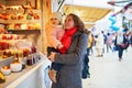 Woman and adorable toddler girl on Christmas market in Paris, France Royalty Free Stock Photo