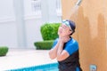 Woman adult in swimming suit water shower cleaning at hotel swimming pool hot day summer season
