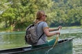 woman adventurous explorer are canoeing in a wild river Royalty Free Stock Photo