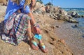 Woman advertises greek sandals on beach