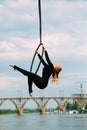 Woman aerialist performs acrobatic elements in hanging aerial hoop Royalty Free Stock Photo