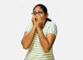 Woman Afraid Closing Mouth with Both Hands on White Background Royalty Free Stock Photo