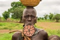 Woman from the african tribe Mursi with a big lip plate