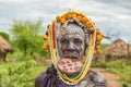 Woman from the african tribe Mursi in her village