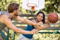 woman against man couple playing basketball