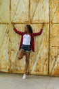 Woman against rusty wall