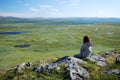 Woman against the tableland with many lakes.