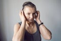 woman aged athlete listens to music through headphones Royalty Free Stock Photo