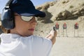 Woman Aiming Hand Gun At Firing Range Royalty Free Stock Photo