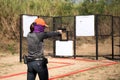 Woman aiming pistol in shooting range