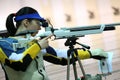 Woman aiming a pneumatic air rifle