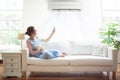 Woman with air conditioner remote control Royalty Free Stock Photo