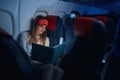 Woman in aircraft cabin looking at book before her Royalty Free Stock Photo