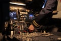 Woman airliner pushing dashboard buttons in plane cockpit