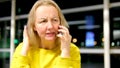 woman at airport talking on phone swearing screaming waving hands in displeasure canceled flight late for plane