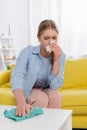 Woman with allergy having snuffle while