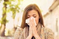 Woman with allergy symptoms blowing nose Royalty Free Stock Photo